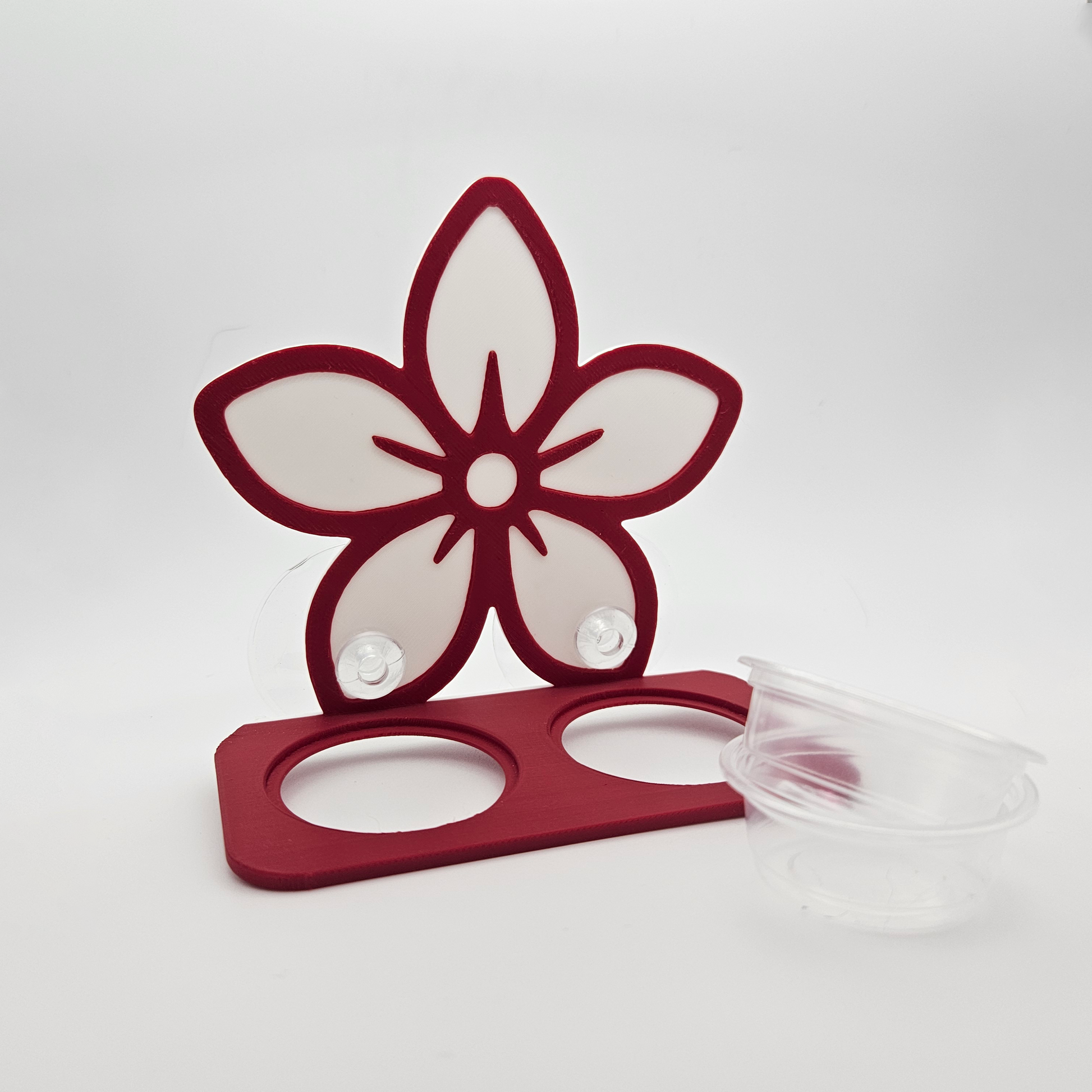 Red metal flower-shaped holder on a white background